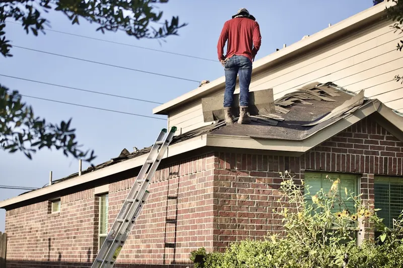 Professional roofer working on a residential roof in Navarre